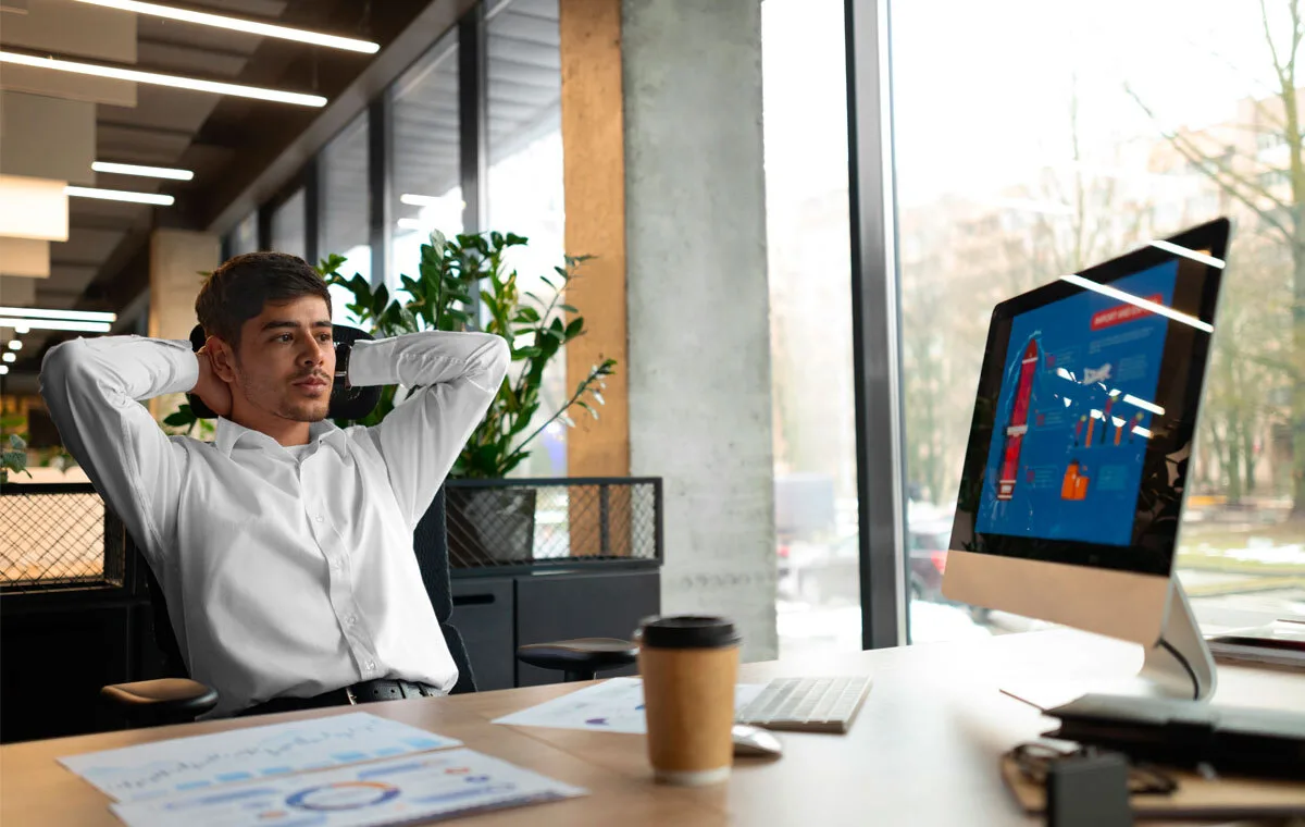 Professional analyzing data on computer screen, reflecting on the future of virtual assistants
