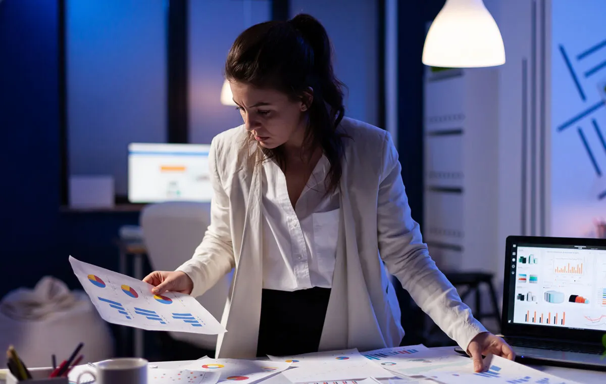 Executive assistant reviewing charts to support product launch and brand marketing strategy.