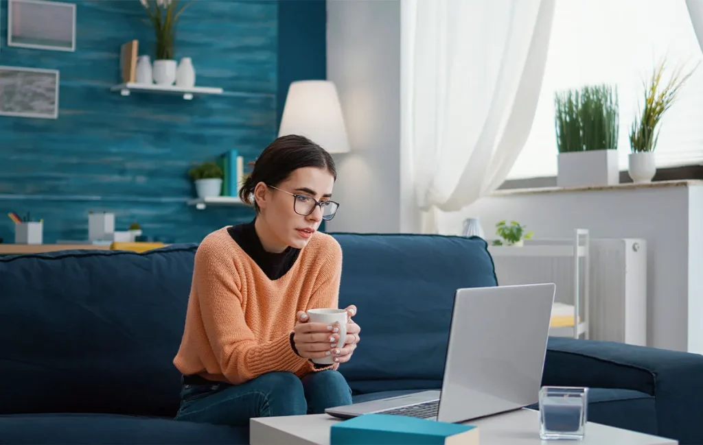 Remote employee attending an online meeting from home office setup, highlighting evolving remote work trends and digital collaboration