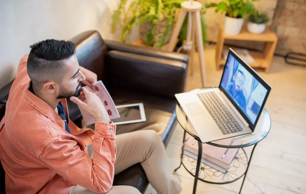 Professional working from home on a laptop during a virtual meeting, representing modern remote work trends and flexible work culture