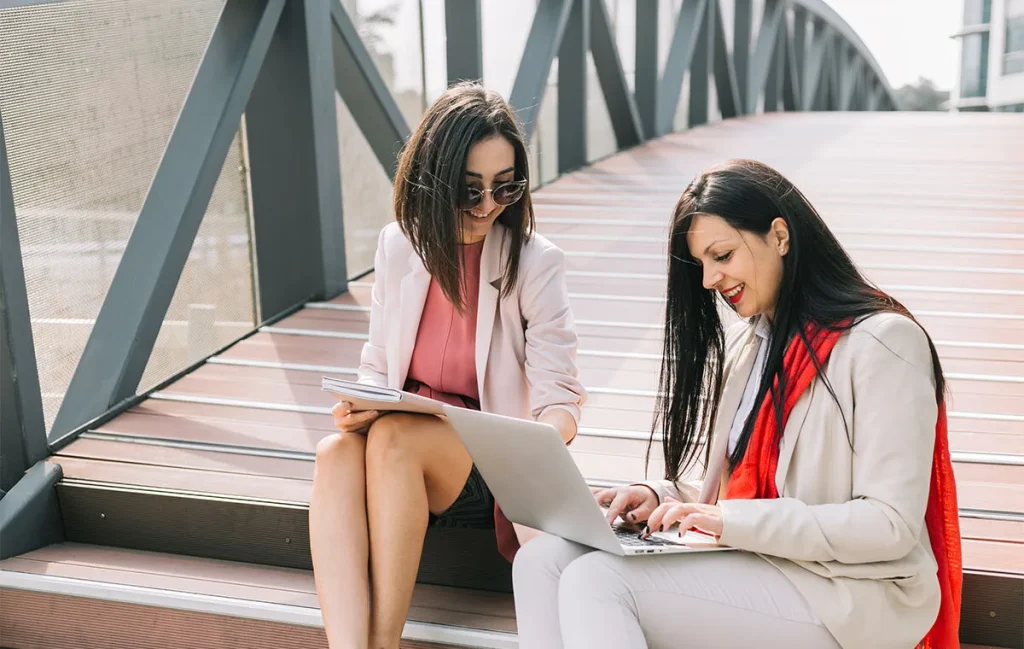 two females executive assistant sharing ideas because culture fit vs culture add was prioritized