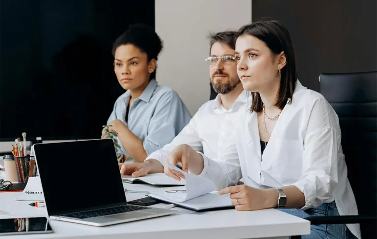 Diverse team discussing culture fit vs culture add hiring strategy in modern office