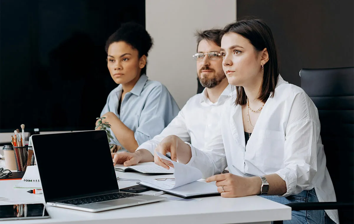Diverse team discussing culture fit vs culture add hiring strategy in modern office
