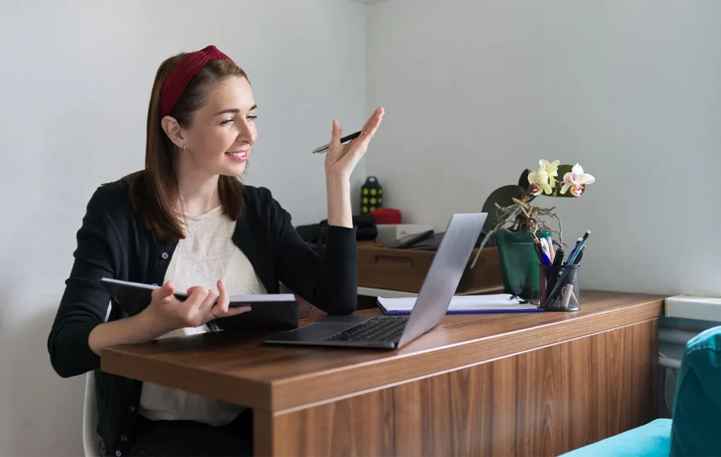 Female executive assistant working remotely from home office showcasing reverse brain drain benefits.