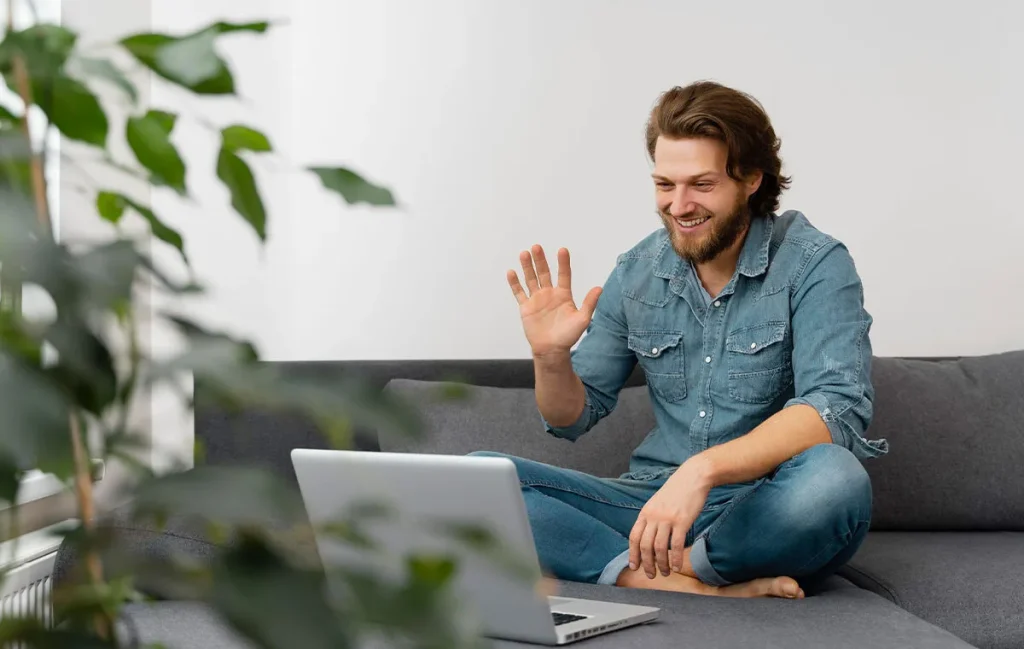 Remote worker smiling during a video call, showing how to build trust in virtual relationships