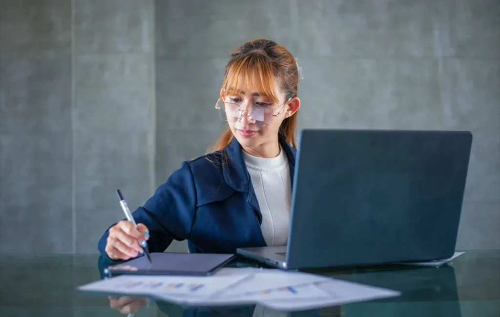 Finance virtual assistant organizing invoices and financial records on a laptop