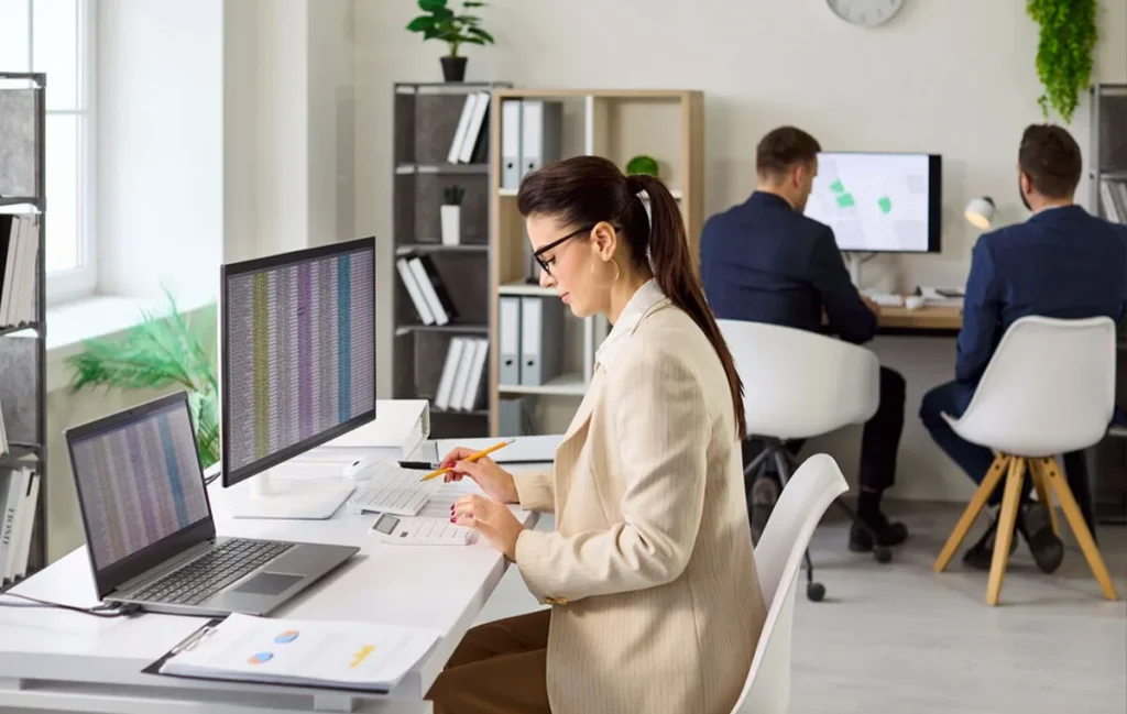 A small business owner tracking expenses and managing financial data with bookkeeping services.