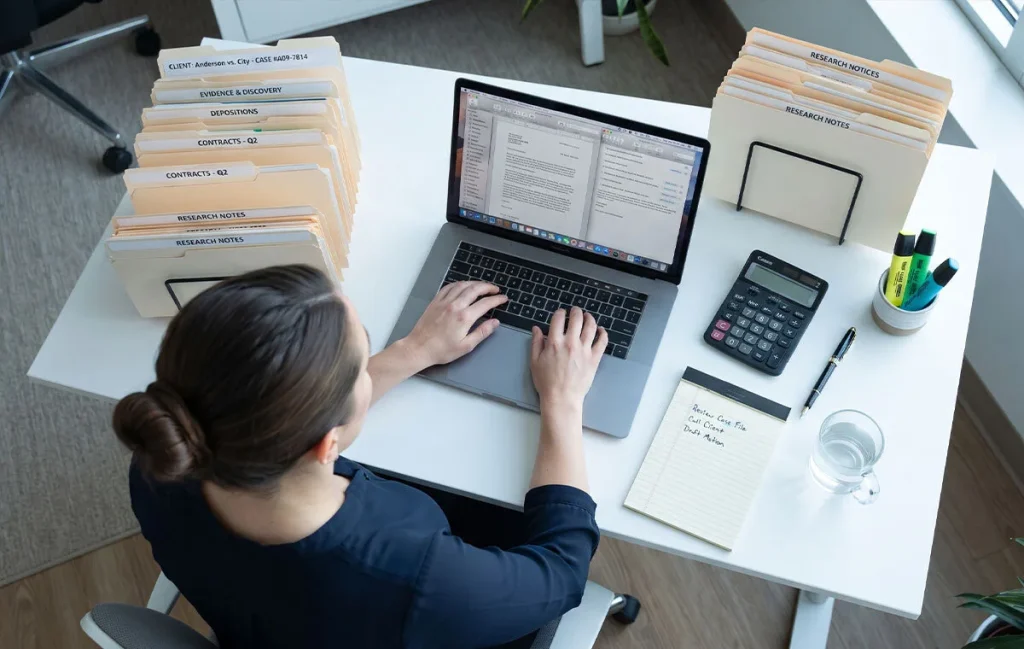 Remote paralegal preparing exhibit lists and drafting legal documents from templates.