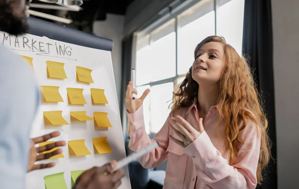 Digital Marketing Manager brainstorming strategy on a whiteboard